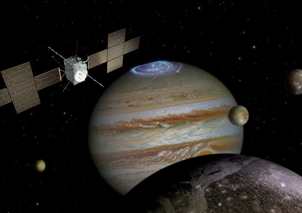 Rappresentazione asrtistica della sonda Jupiter fra Giove e alcune delle sue lune (fonte: ESA) © Ansa