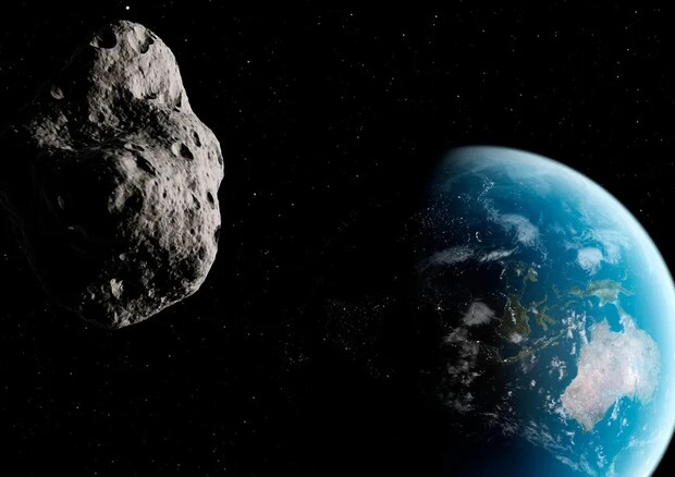 Rappresentazione artistica del passaggio di un asteroide vicino alla Terra (fonte: Sebastian Kaulitzki/Science Photo Library/Corbis,  CC0 1.0 Universal Public Domain Dedication) © Ansa