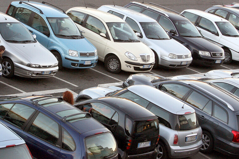 Una fila di automobili in un parcheggio a Roma - RIPRODUZIONE RISERVATA